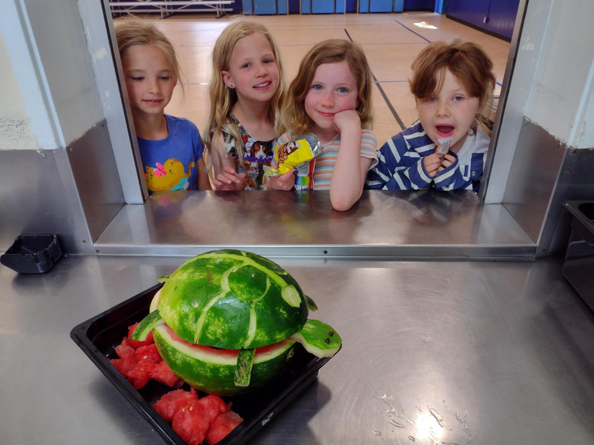 Students watching watermelon carving