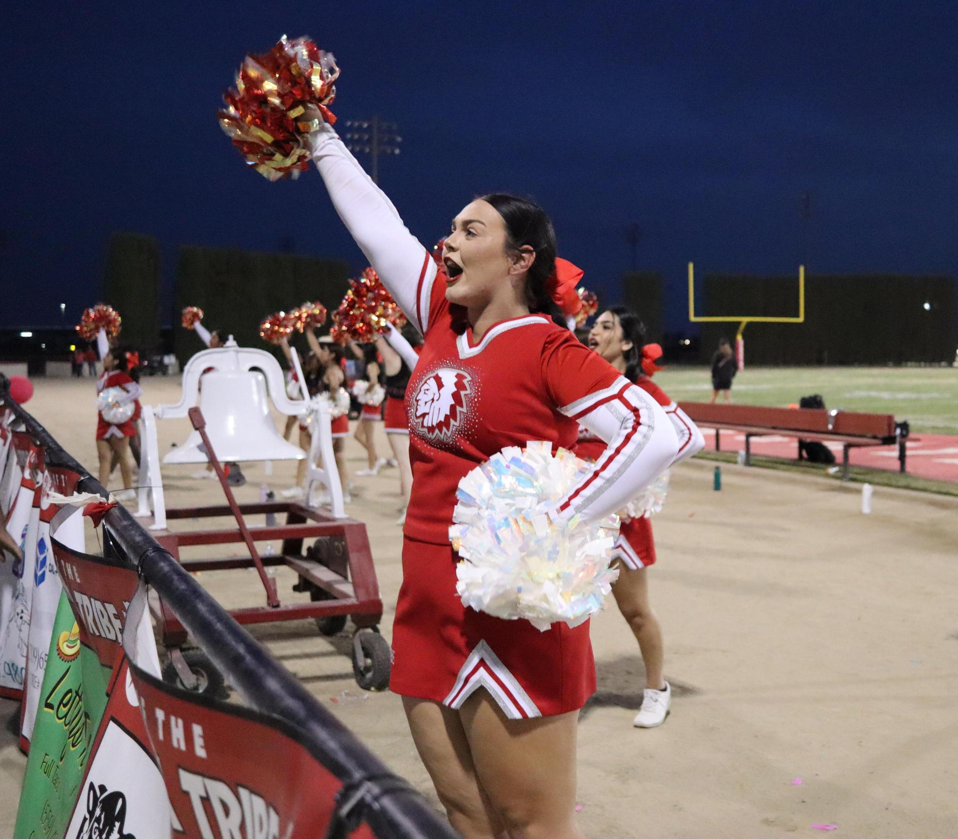 varsity cheerleaders in action at the Riverdale game