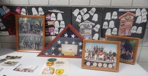 Photos, honors and awards, and letters are displayed for Veterans Day.