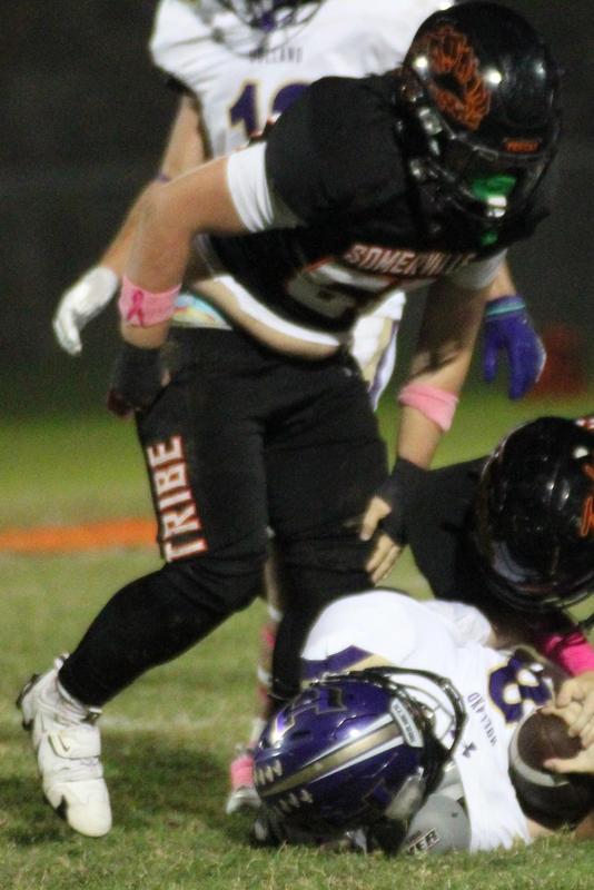 Football player tackles an opponent on the field during a game.