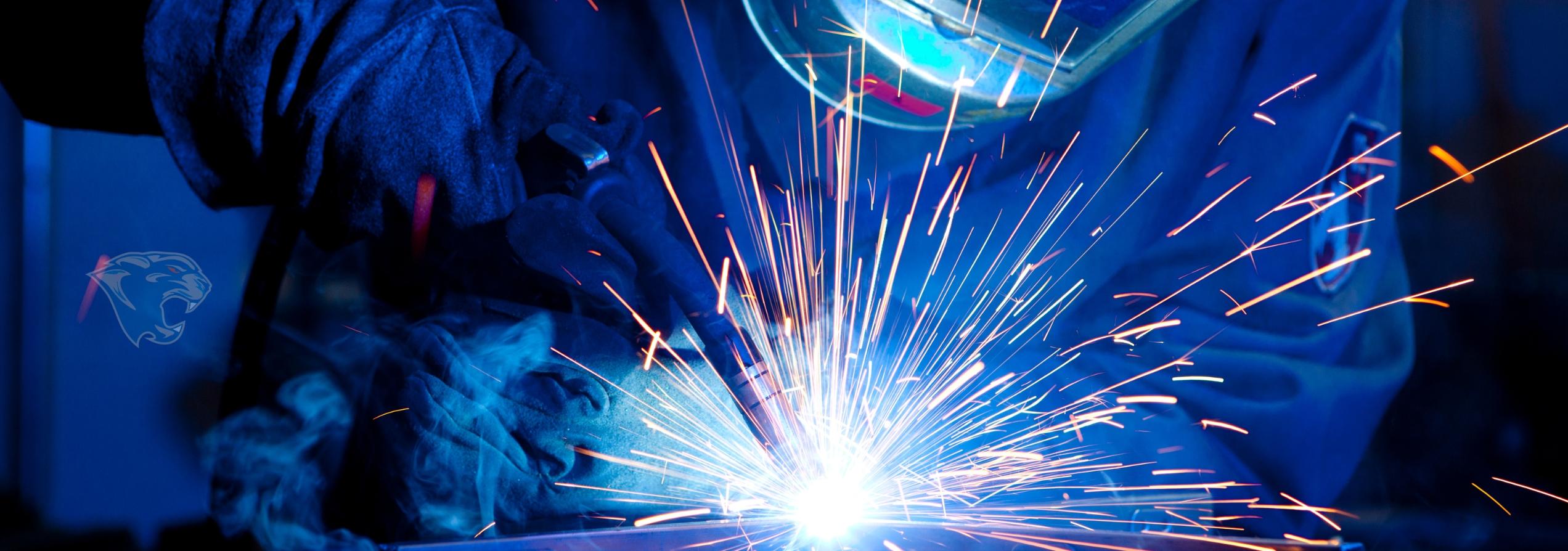 student actively welding