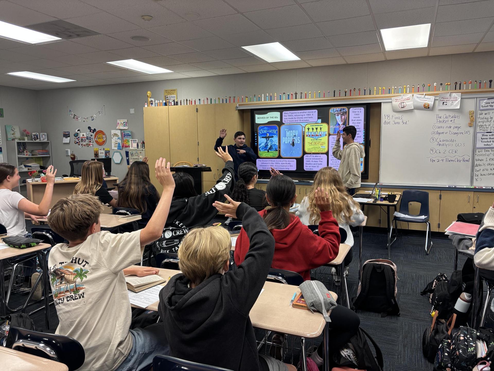 Seventh grade honors language arts students present their Outsiders slide show to the class.