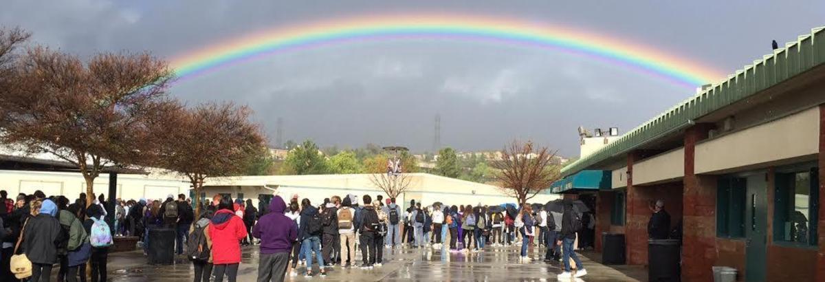 A rainbow over Valencia High School as students walk to class.