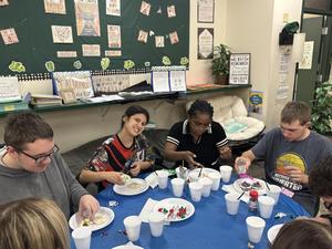 Students enjoying a festive dessert activity at a table with colorful toppings.