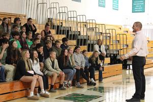 Students sit in gymnasium
