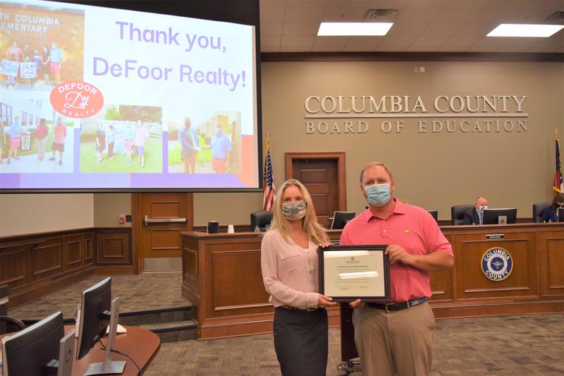 two people holding certificate