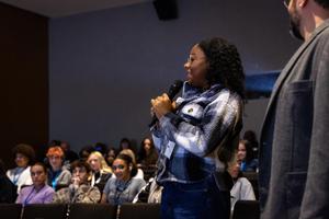 A student speaks in an auditorium