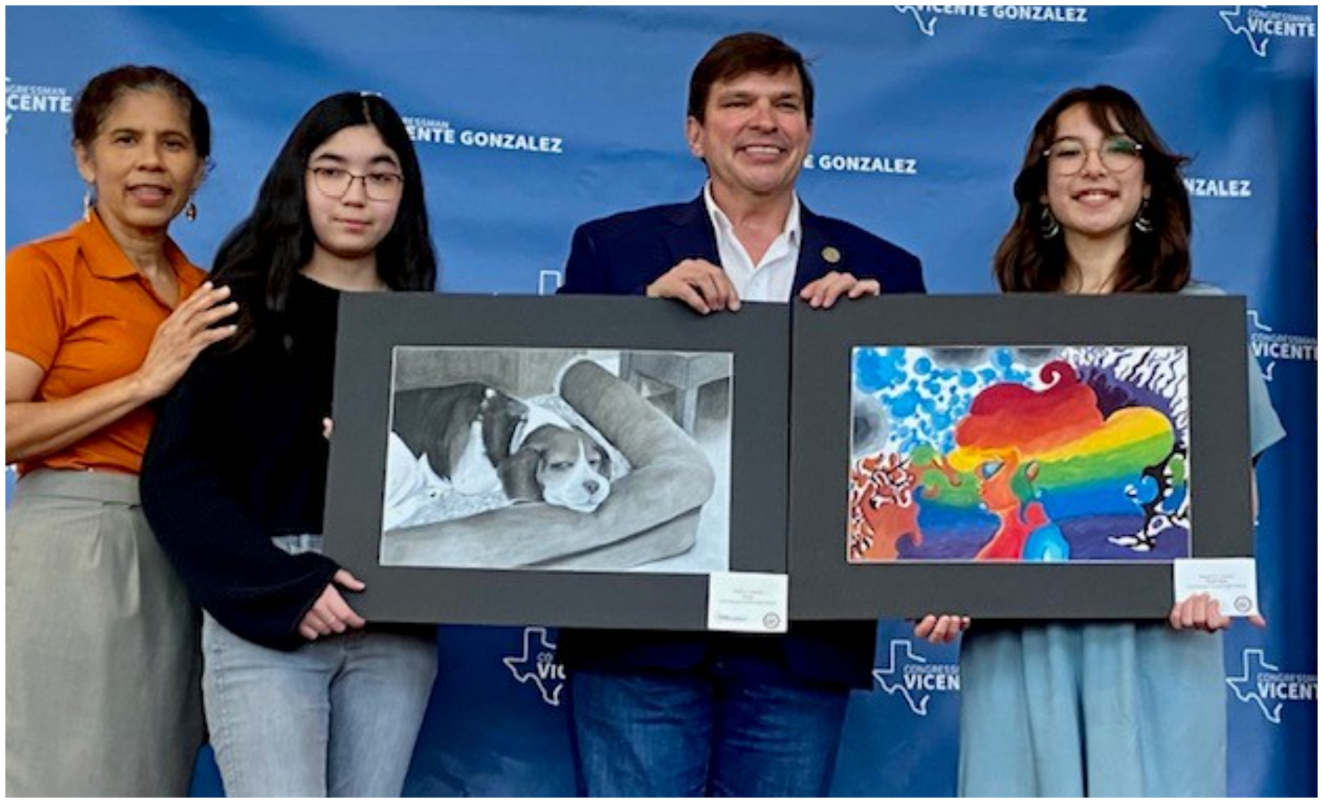 Art contest winners with parents and plaques