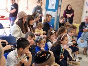 The studends and gusts are amused by the Parsha performance.