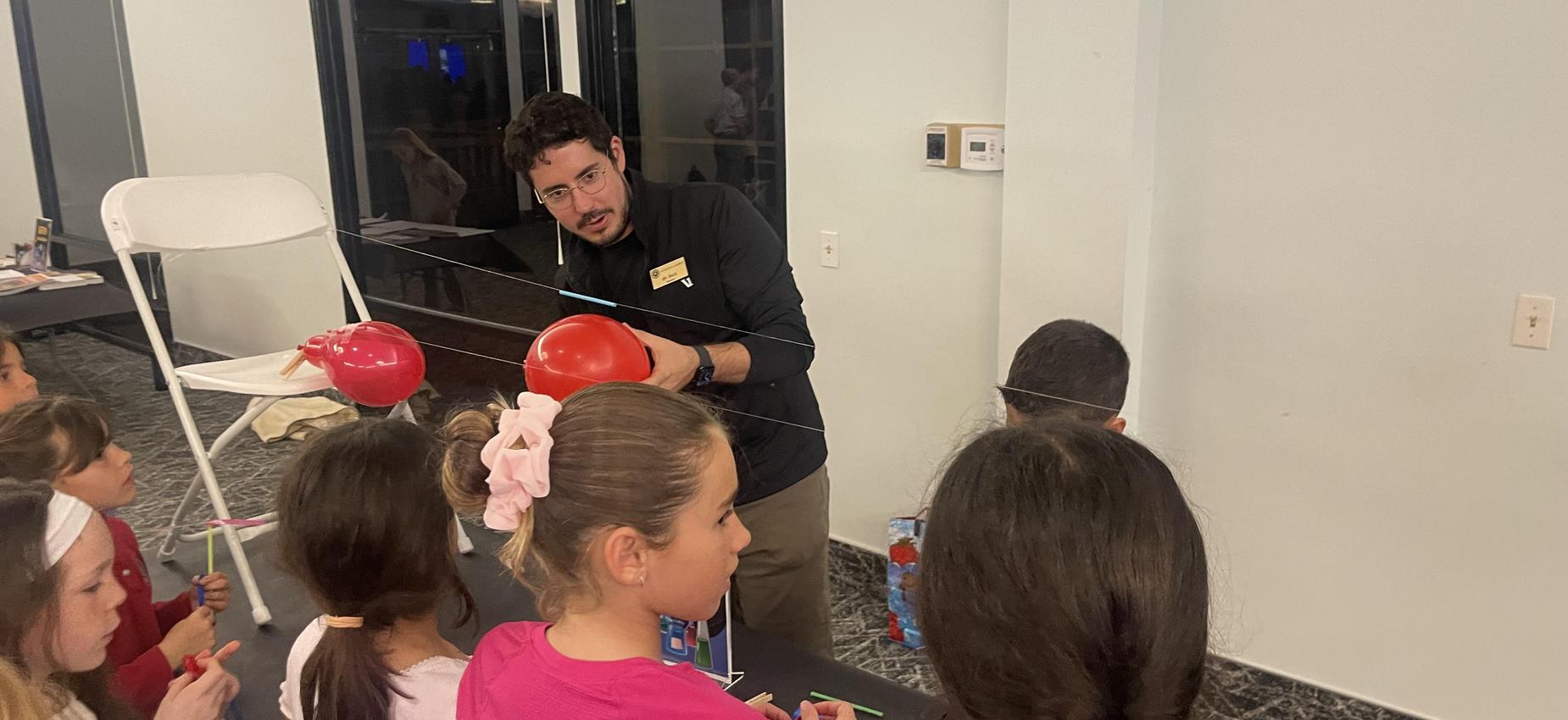 4th grade teacher demonstrating science experiment