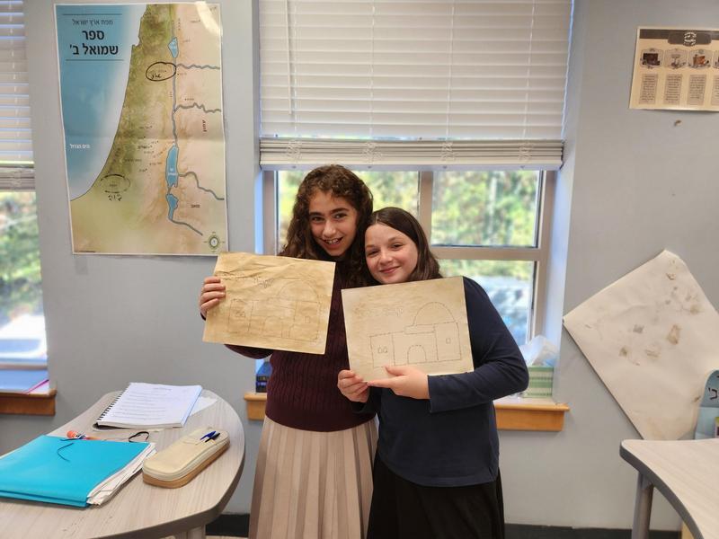 Two students display their kever rachel projects.