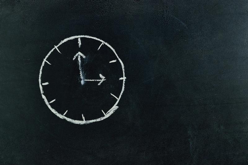 Chalkboard with a clock drawn on it
