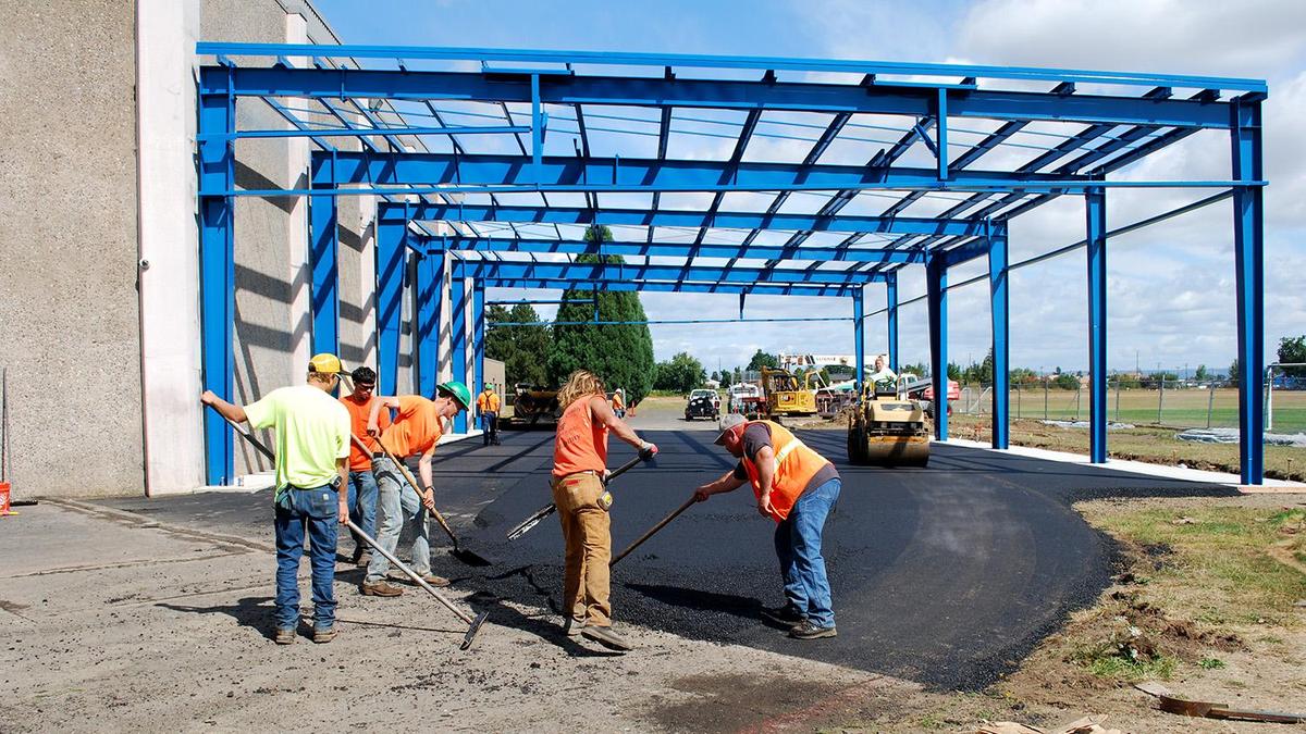 laying asphalt under play structure