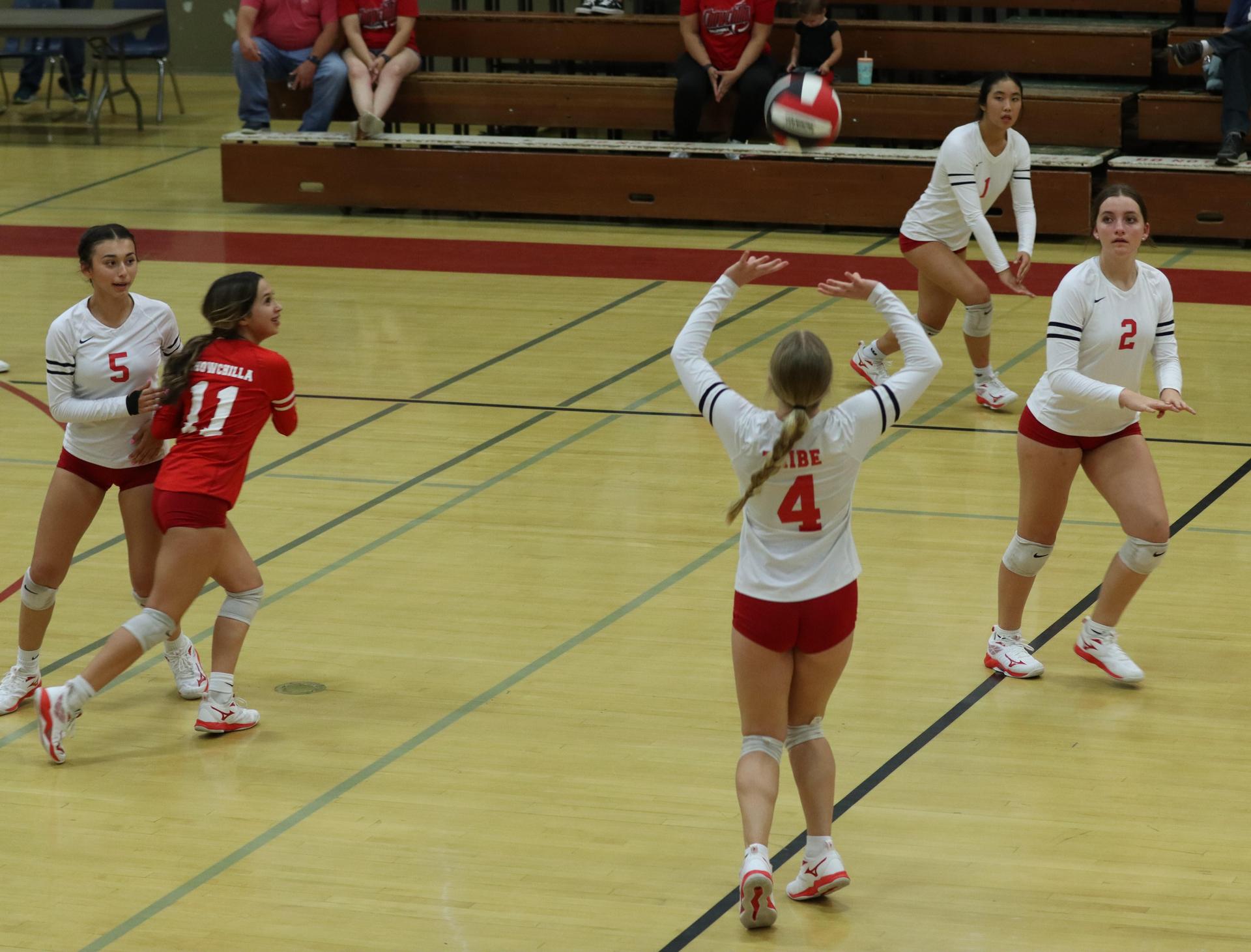 varsity volleyball players in action against liberty