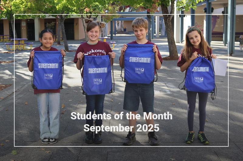 Students holding a bag