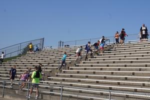 A line of students and a firefighter climb stairs in the stadium on Sept. 11.