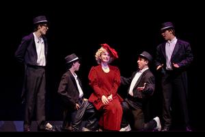 Five performers during a piece from the show