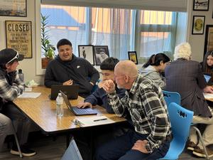 Community member working with a make student at his computer