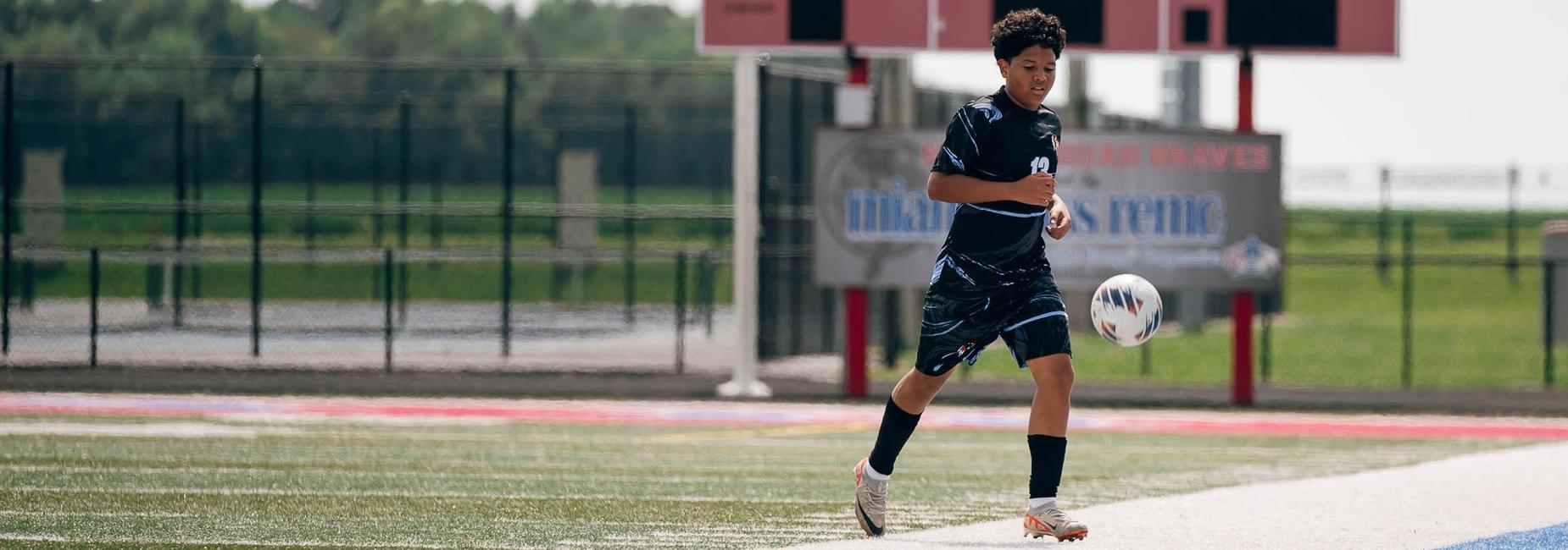 Kid kicking a soccer ball