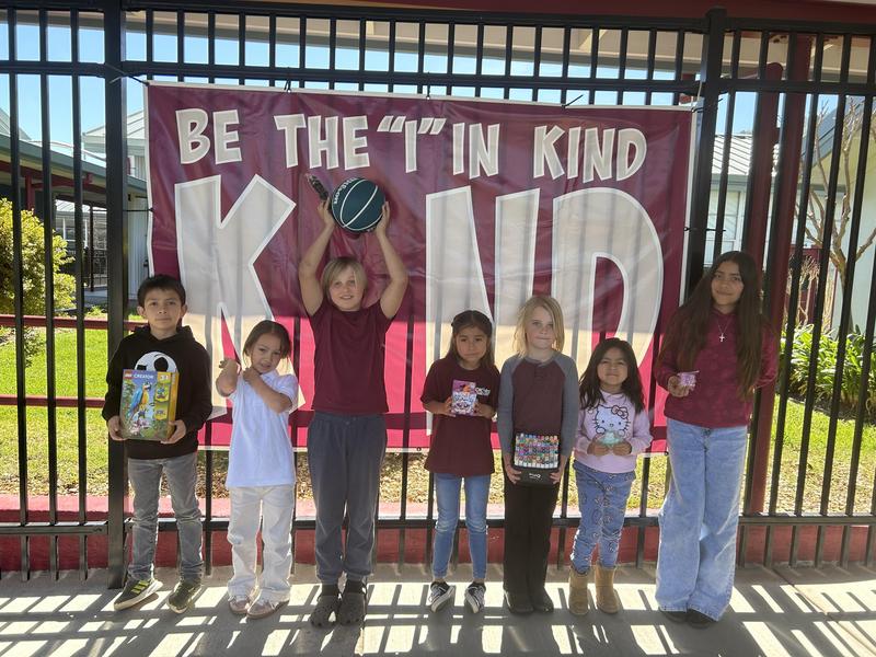 Students holding a toy