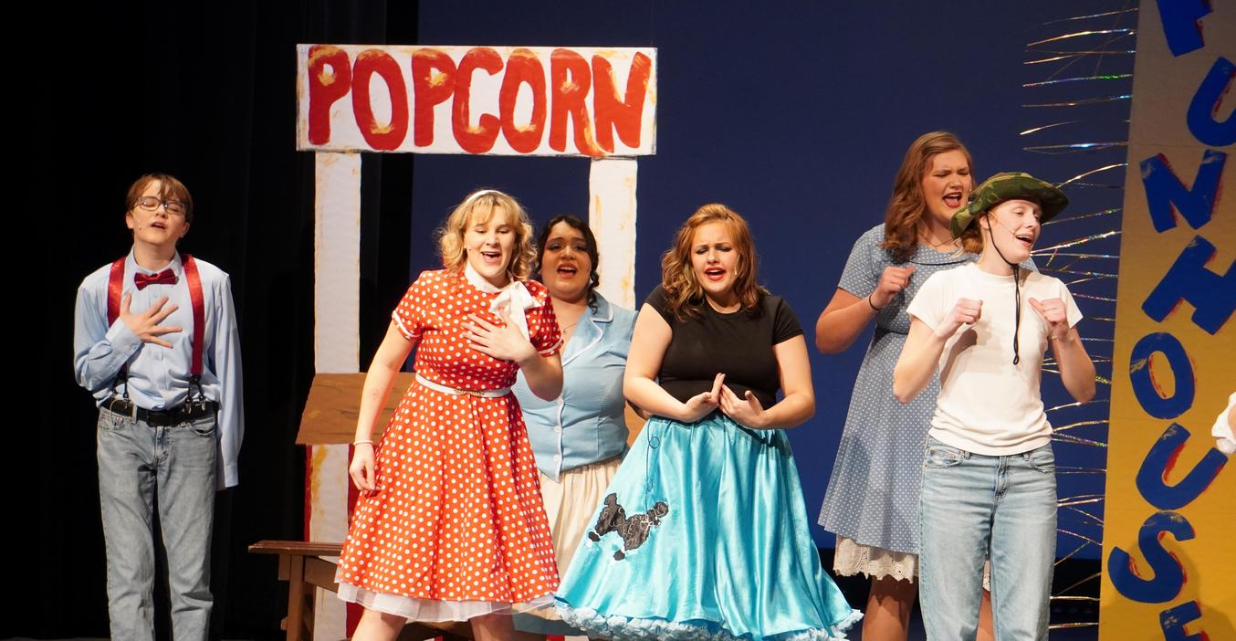 Several students perform a song in the spring musical.