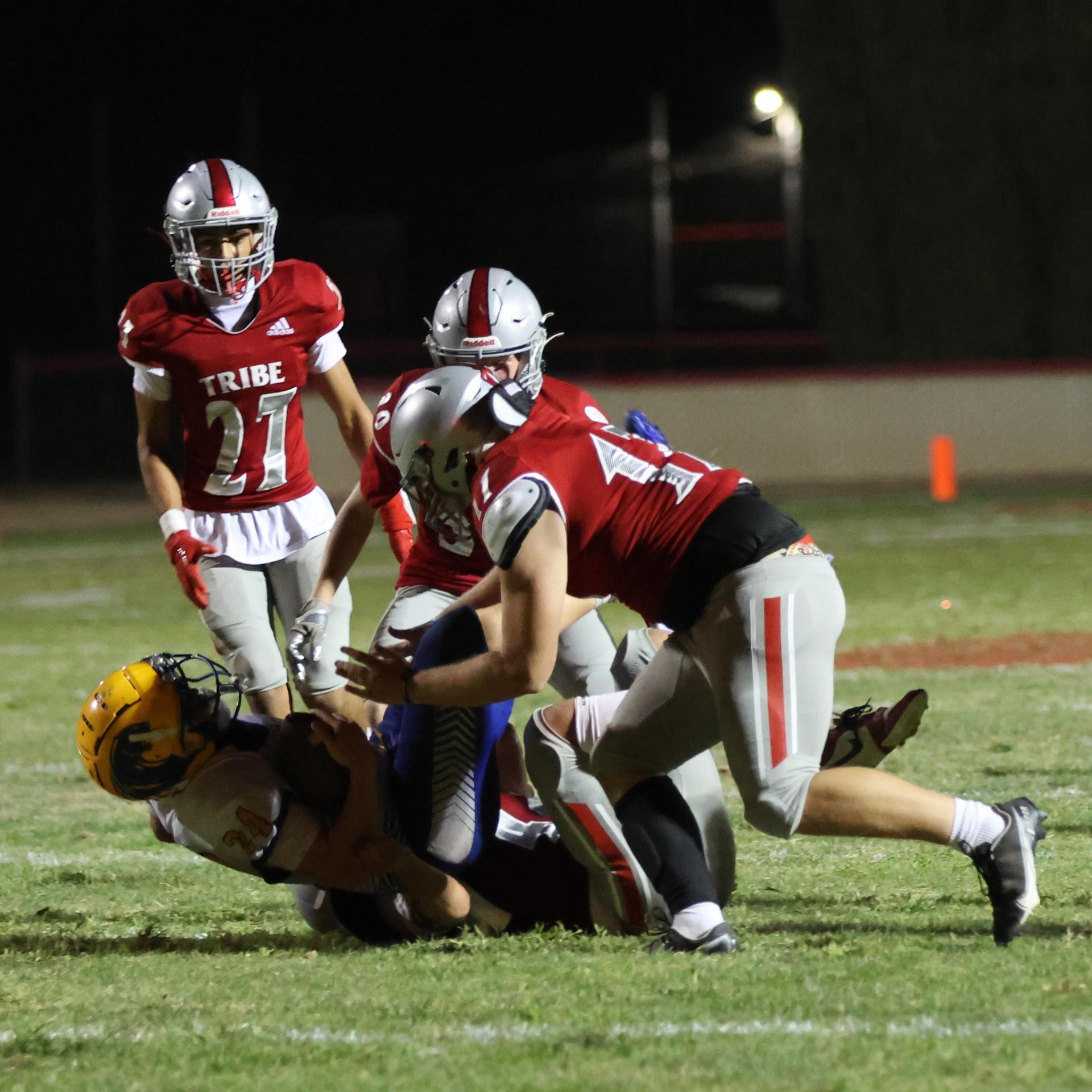 Varsity football players in action against Parlier 103