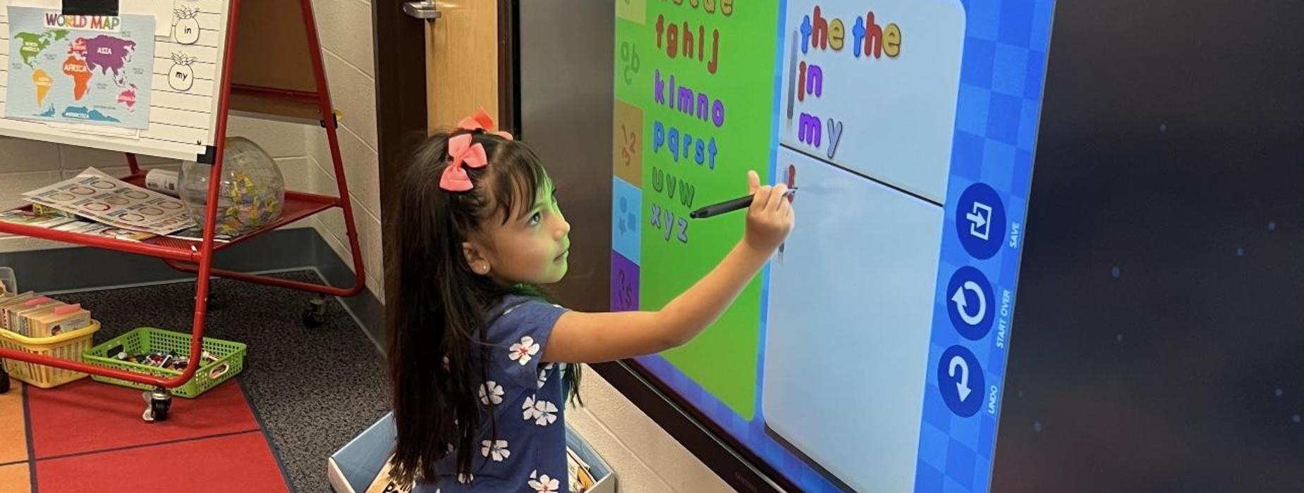 Student writing on board