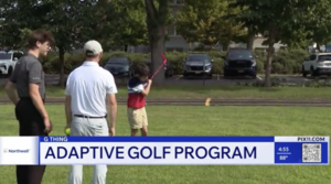 two instructors watch as a boy swings the golf club on a field