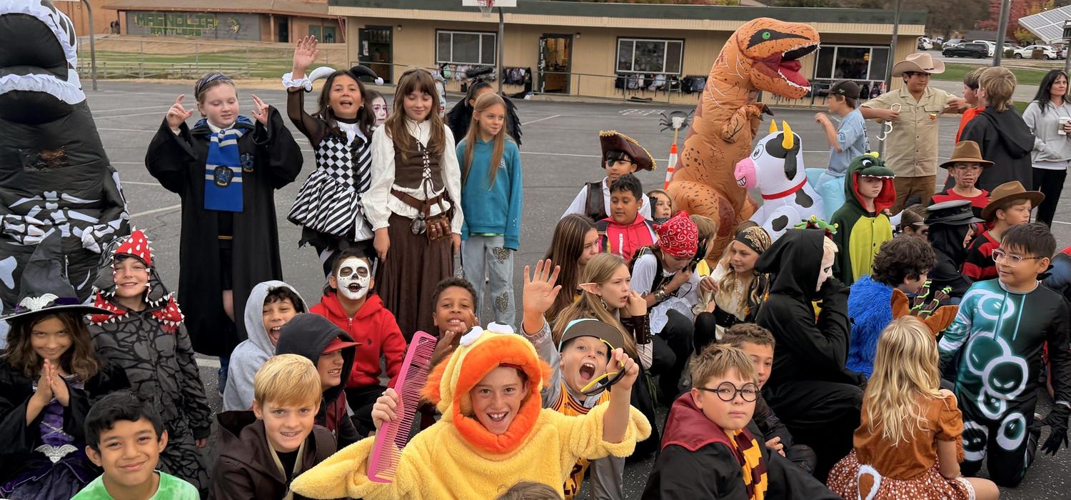 Students gather on the blacktop in costumes