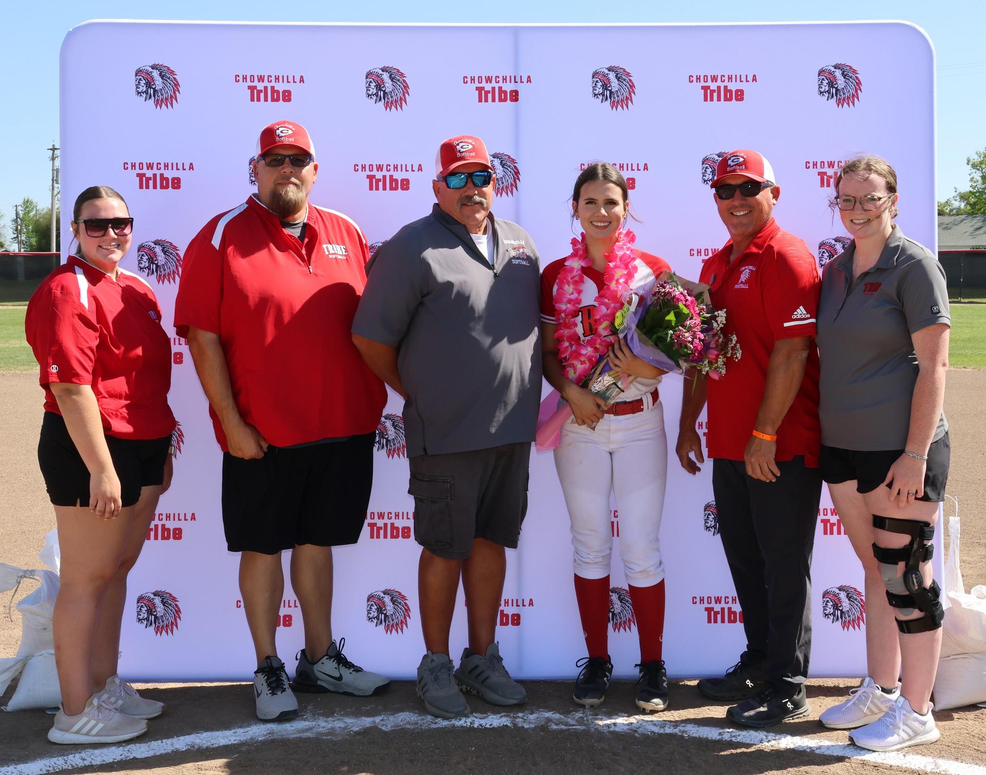 Seniors Posing With Teammates, Coaches, And Family