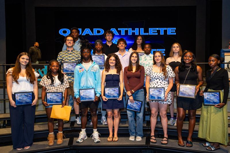 Quad and tri-athletes pose