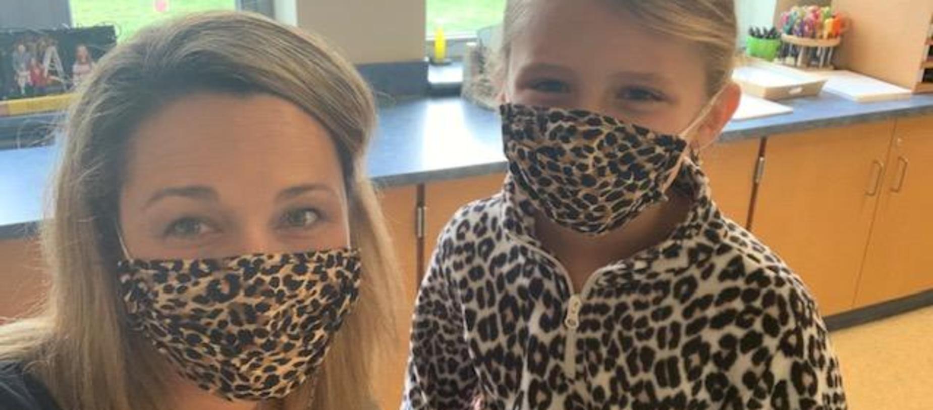 teacher and student wearing matching leopard masks
