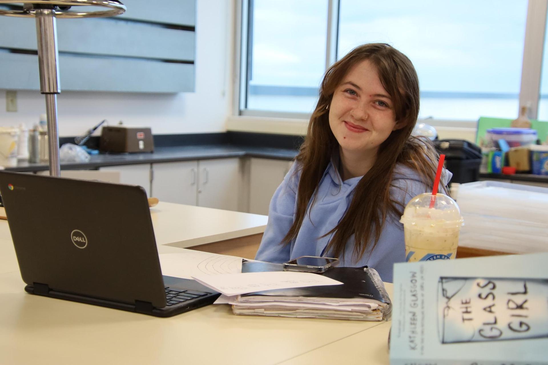 Student smiling in a classroom