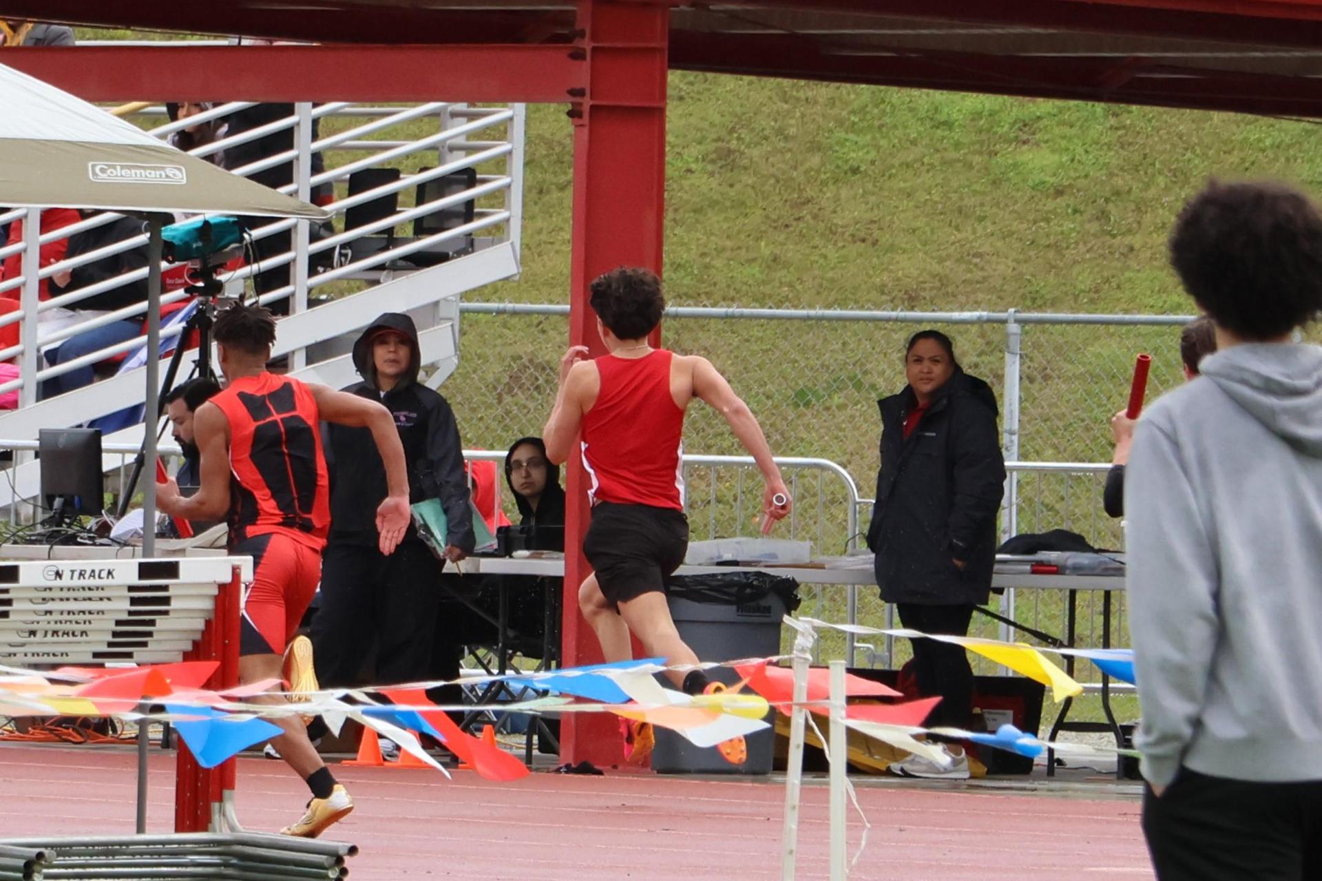 junior varsity boys running the four by 100 meter relay