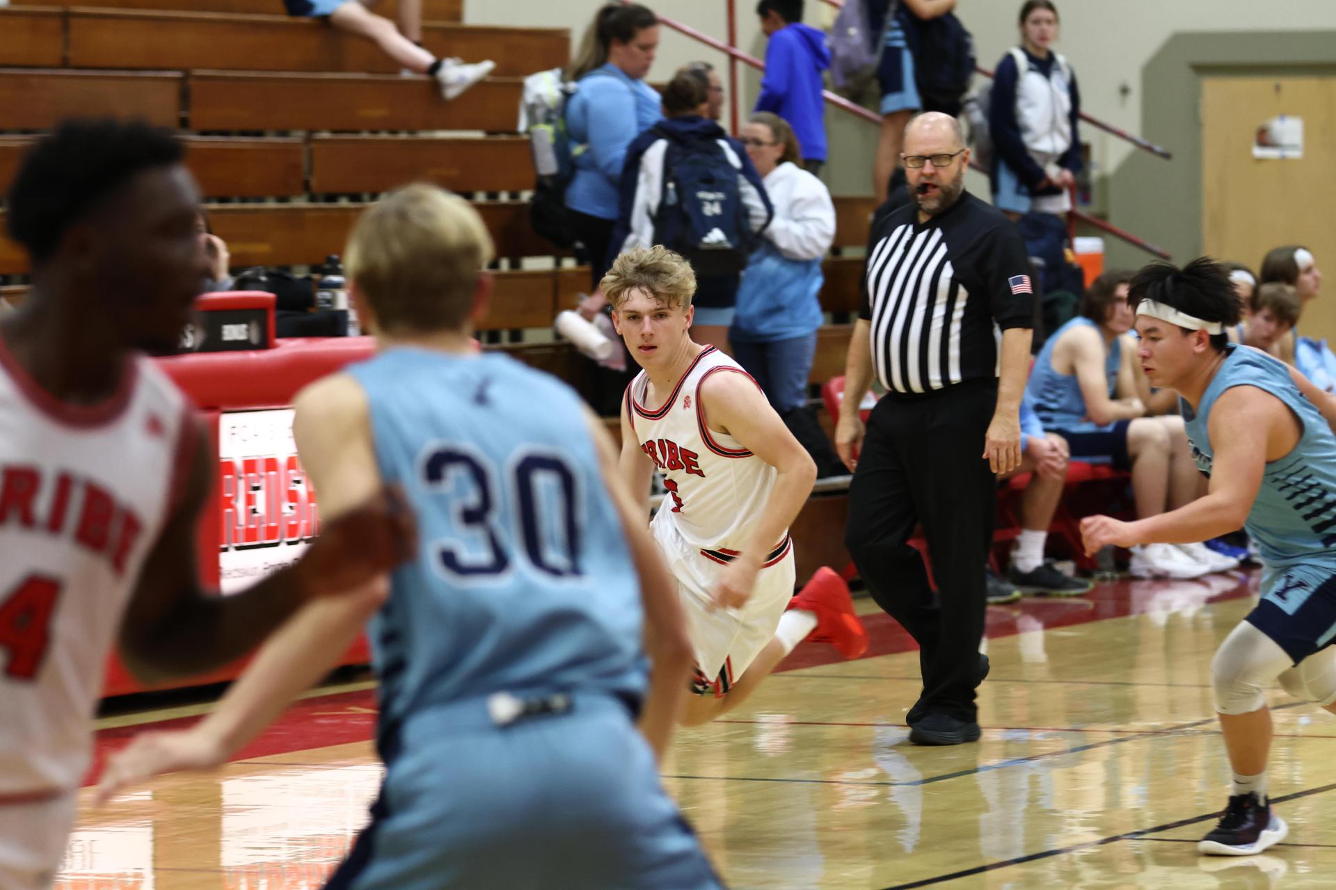 Varsity boys playing basketball against yosemite