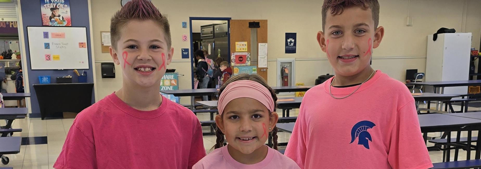 3 students wearing pink