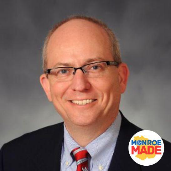 Joe Sherlin, a suit with glasses and the Monroe Made logo in the corner.