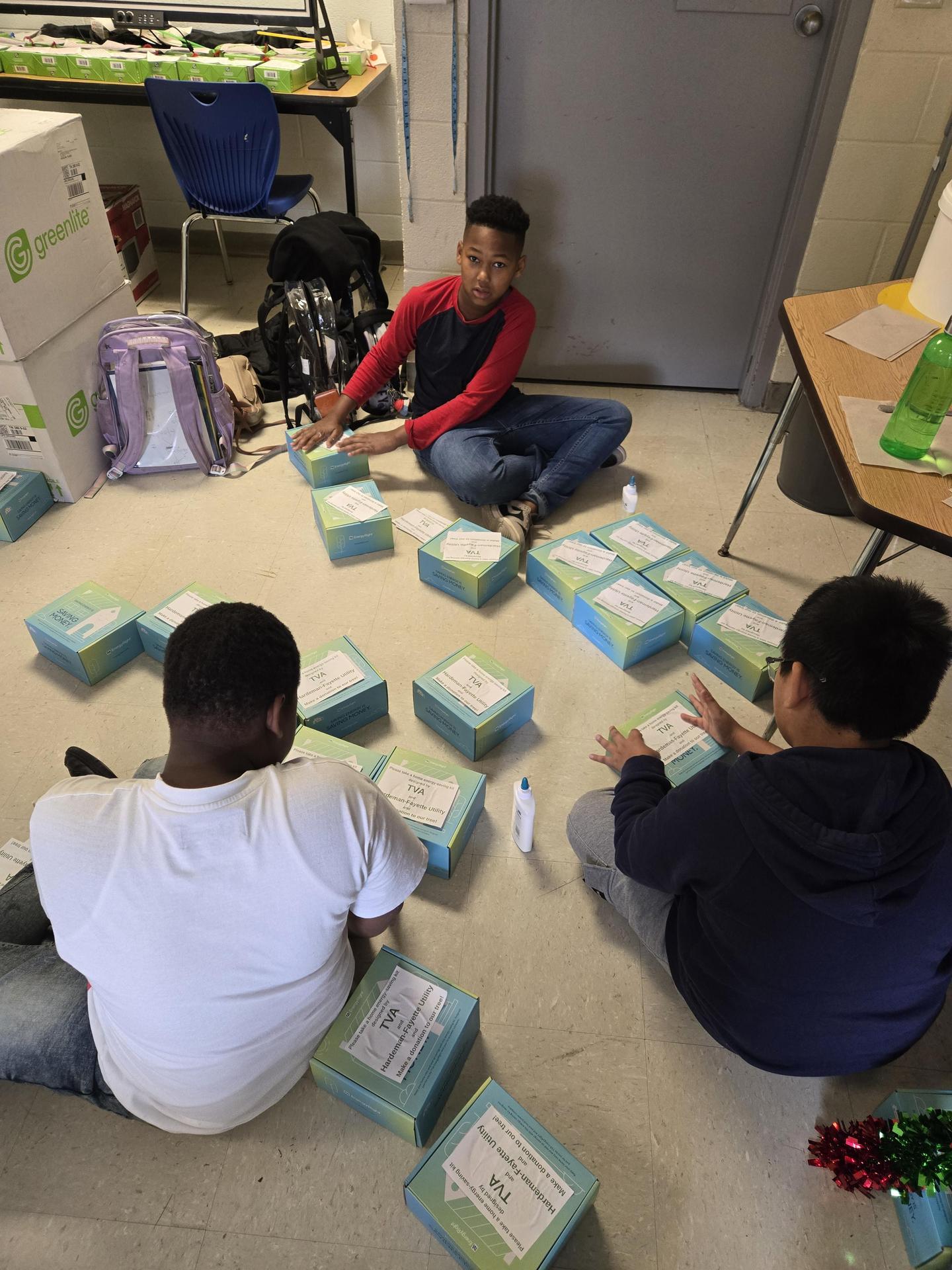 uplift students getting ready to package lightbulbs