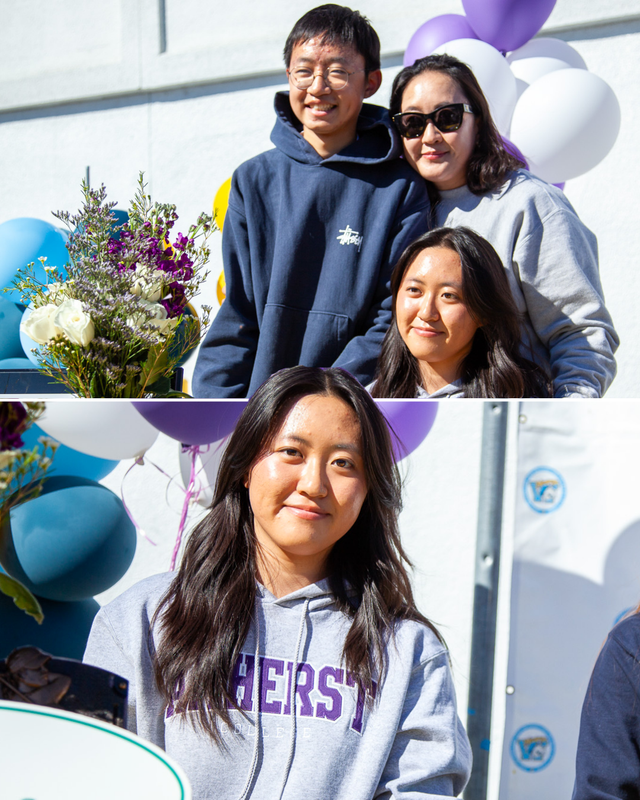 Cheerful girl poses with her family, surrounded by colorful balloons and flowers.