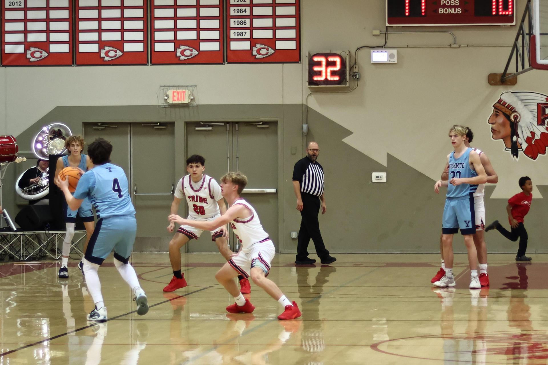 Varsity boys playing basketball against yosemite 