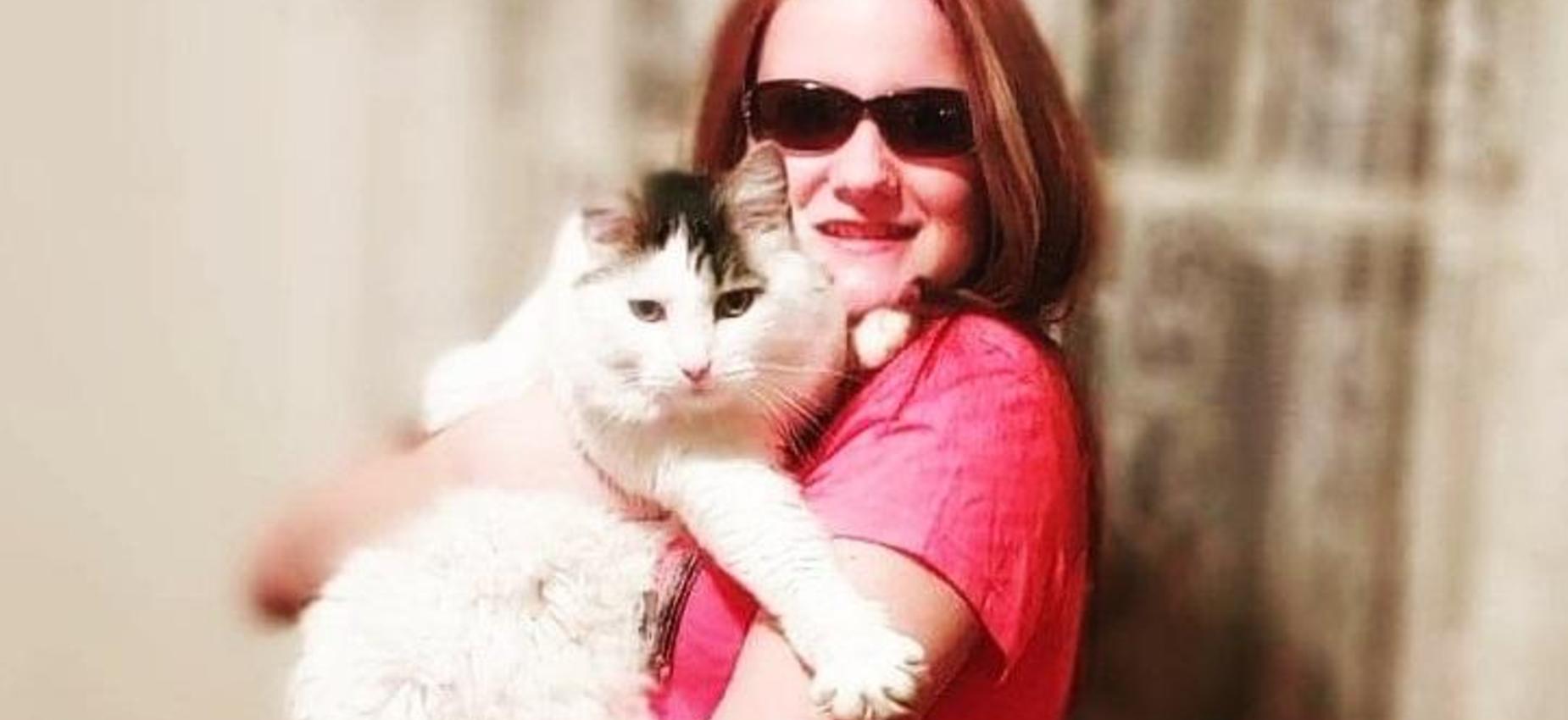 A student holds a cat.