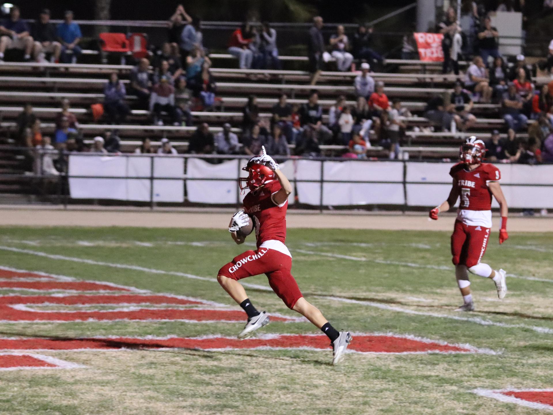 varsity football players in action against Riverdale