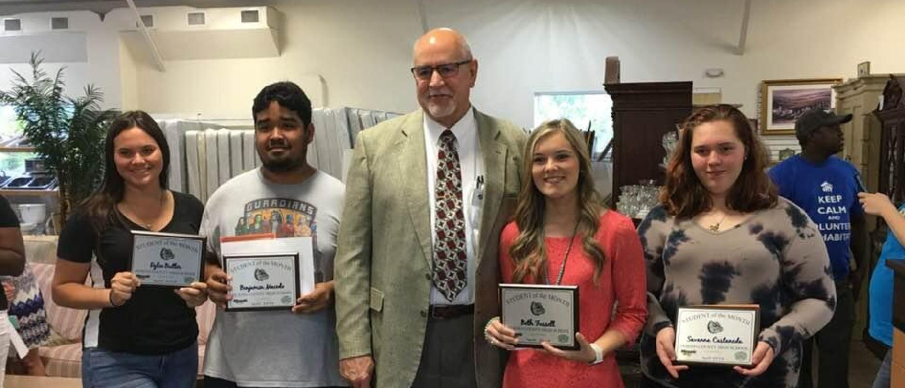 Students of the month take a picture with Mr. Bremer.