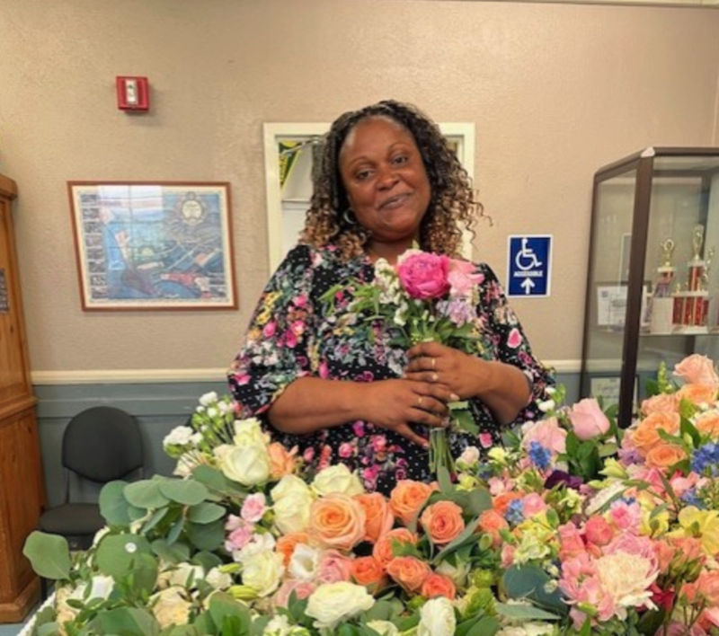 Dr. Tamika McKenzie with colorful flowers