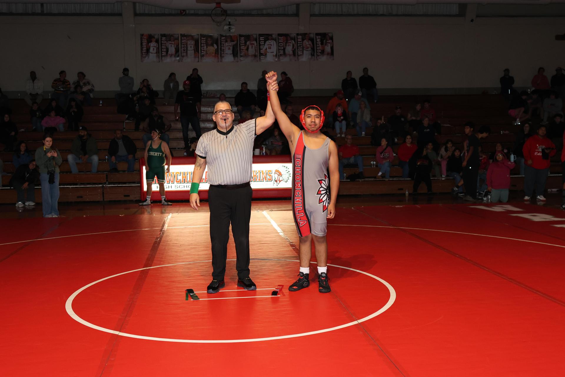 Wrestling winners with hands up 131