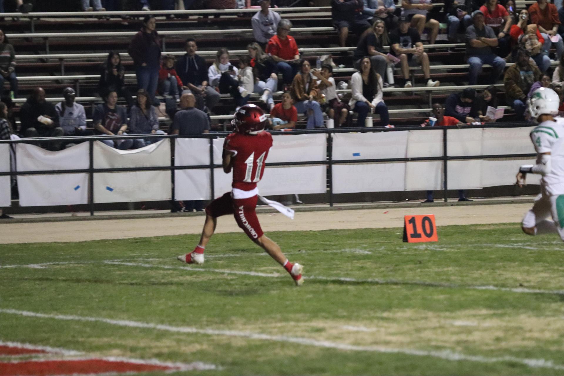 varsity football players in action against Riverdale