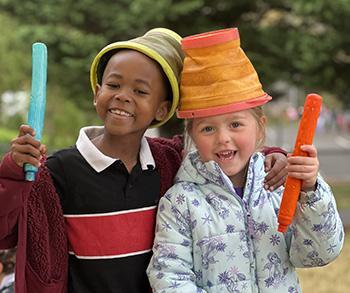 JRDS 1st graders playing dress up with playground buckets
