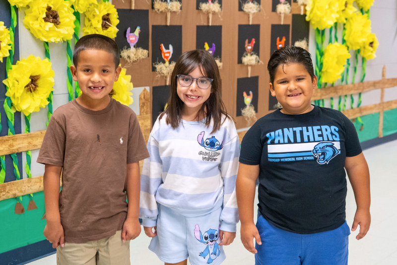 Westwind students standing in in front of Agriculture hallway decorations.