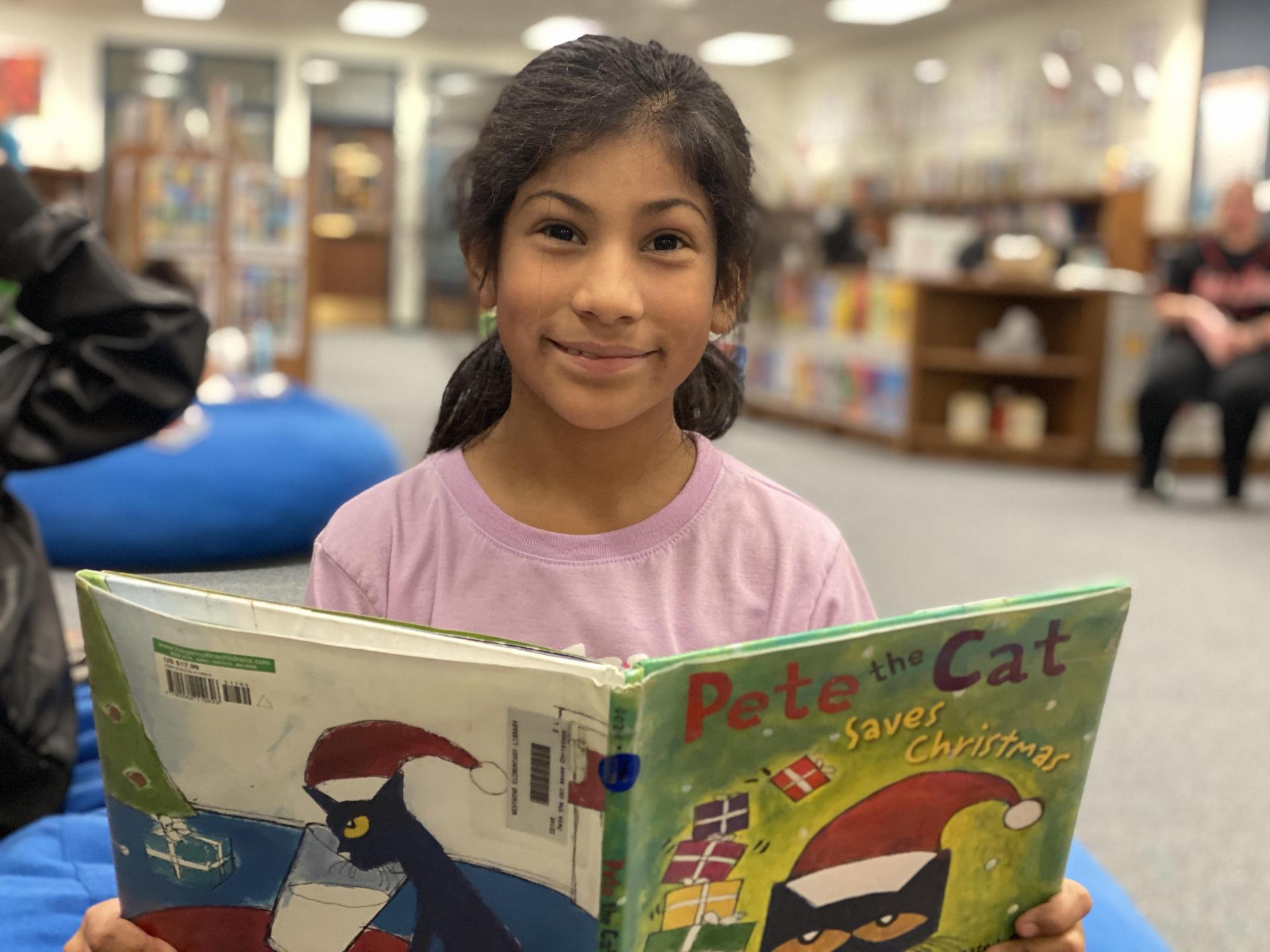 Smiling girl reading a book