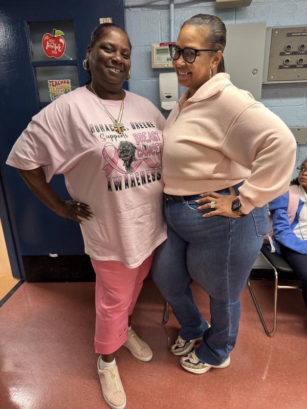 Staff member and school secretary wearing pink